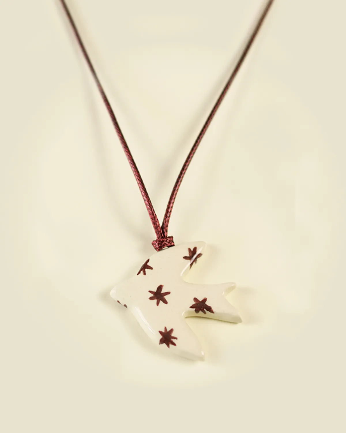 BEIGE & BURGUNDY SWALLOW PENDANT